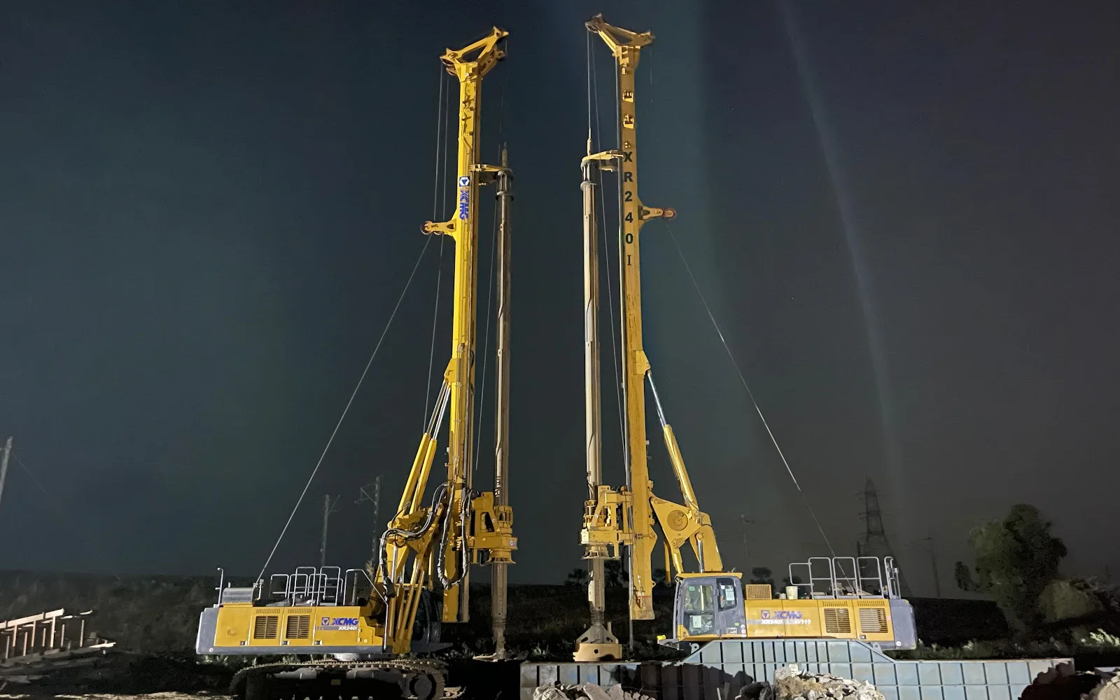 Foundation rigs operating at night under site lighting